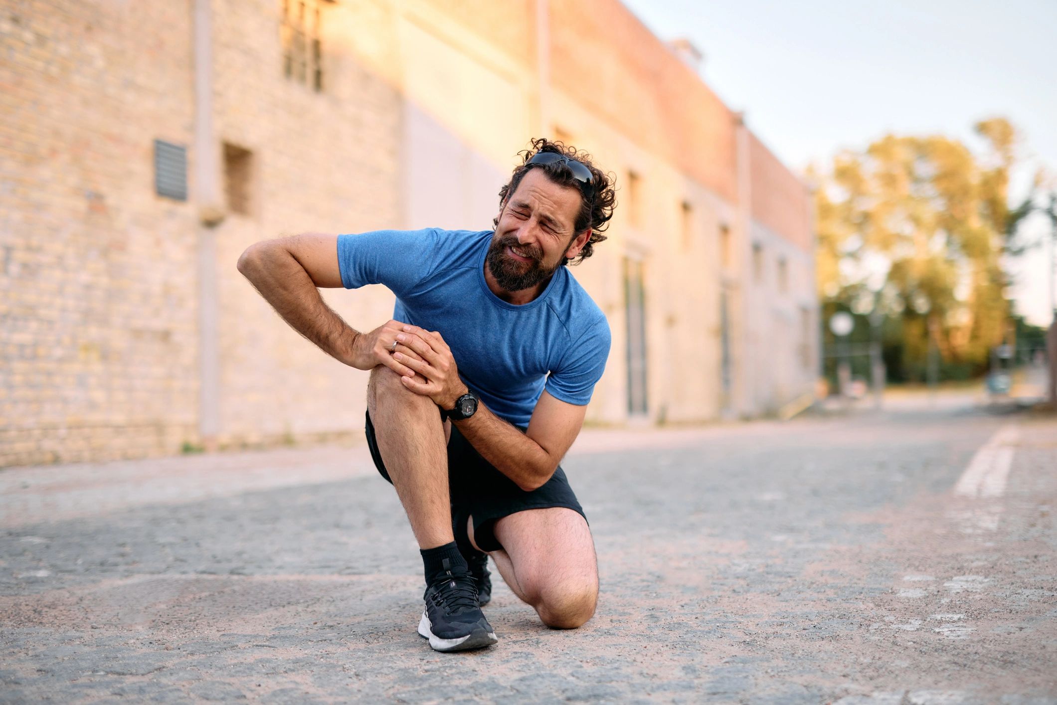 Man holding his knee in pain representing knee pain treatment in Frederick MD
